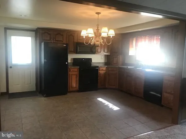 a kitchen with refrigerator and window