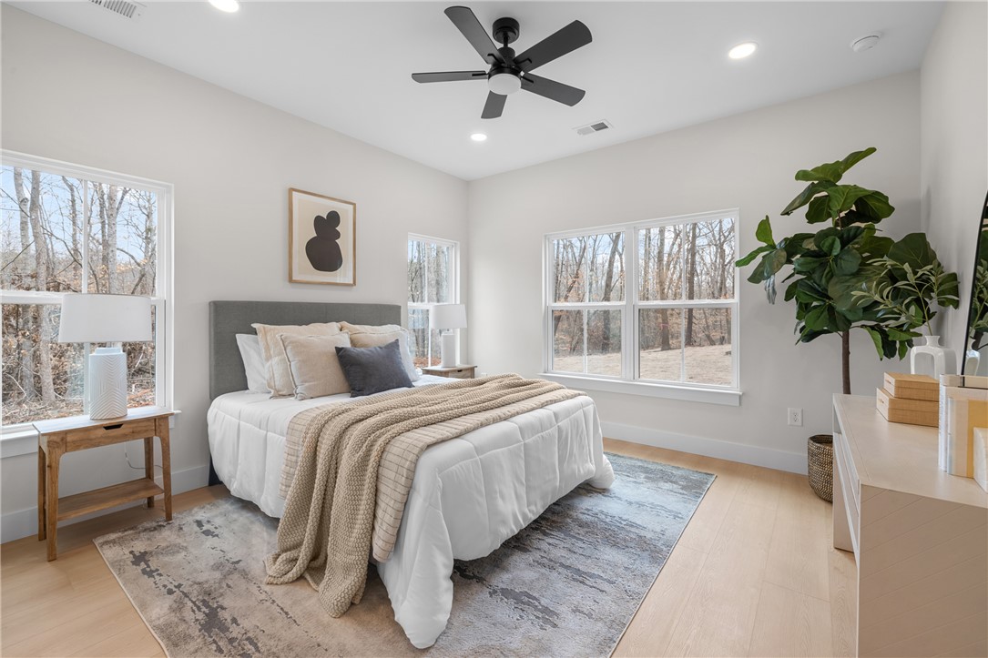 502 Point Road Westminster, SC 29693 - Photo 15 of 45 Primary bedroom Bright and airy with large windows offers serene views of the surrounding natural landscape.