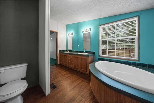 a spacious bathroom with sink shower and mirror