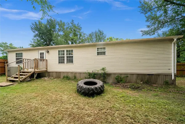 a backyard of a house with barbeque oven and seating space