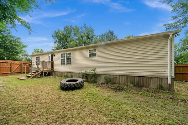 a backyard of a house with table and chairs