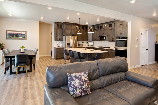 983 South 950 West Provo, UT 84601 - Photo 11 of 56 Open-concept living space featuring wood-finish flooring, recessed lighting, and a neutral color palette