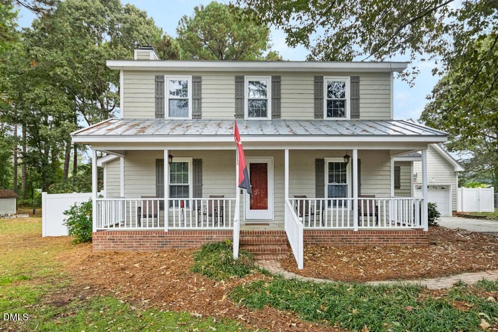 106 Village Court Garner, NC 27529 - Photo 1 of 38 a front view of a house with a garden