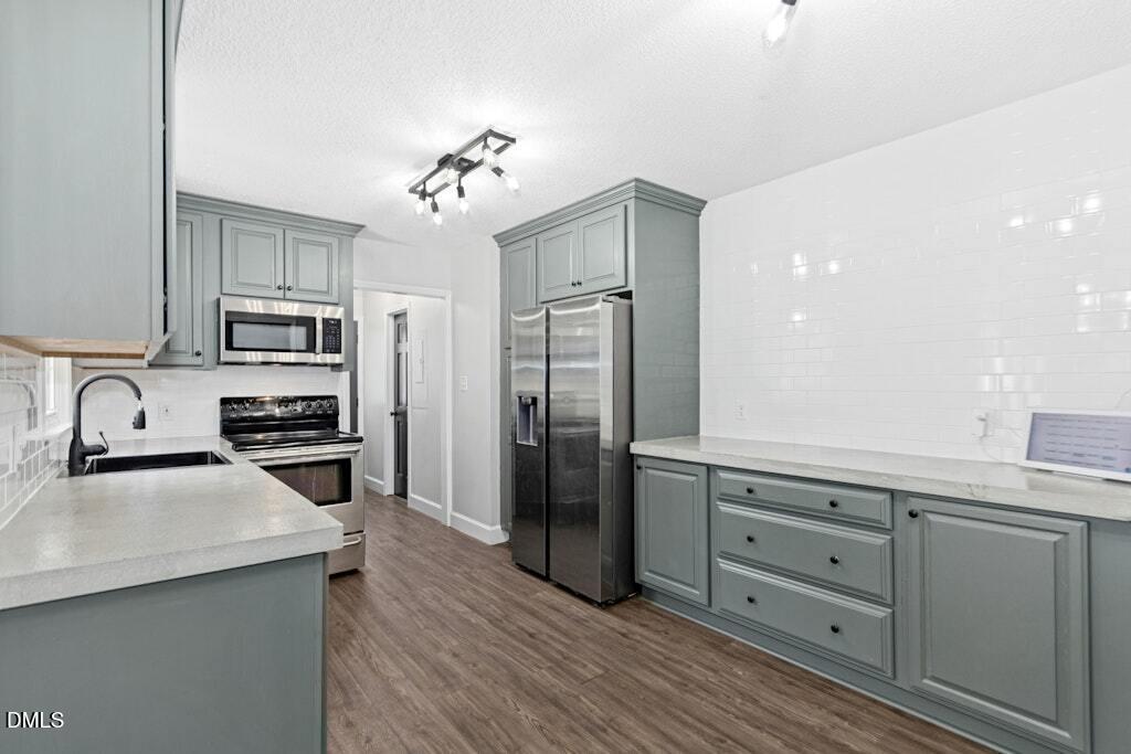 106 Village Court Garner, NC 27529 - Photo 11 of 38 a kitchen with stainless steel appliances granite countertop a refrigerator and a stove top oven