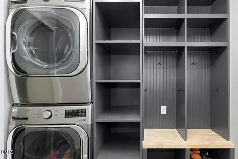 a living room with wooden floor furniture and a ceiling fan