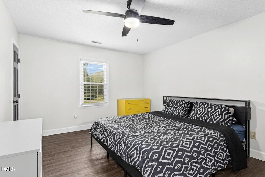 106 Village Court Garner, NC 27529 - Photo 16 of 38 a bedroom with a bed and wooden floor