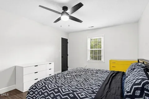 a kitchen that has a sink cabinets and a wooden floor