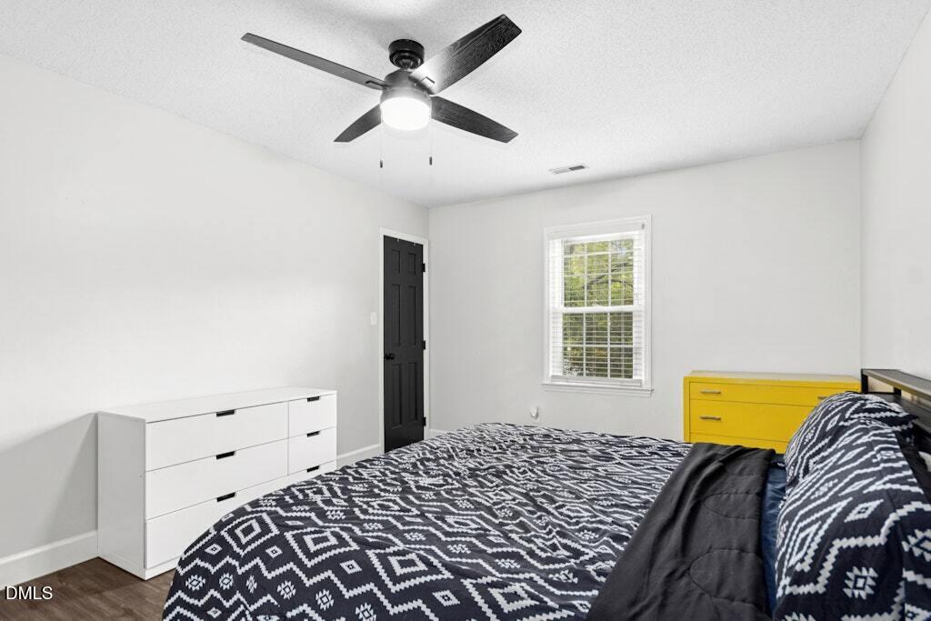 106 Village Court Garner, NC 27529 - Photo 17 of 38 a bedroom with a bed and a lamp