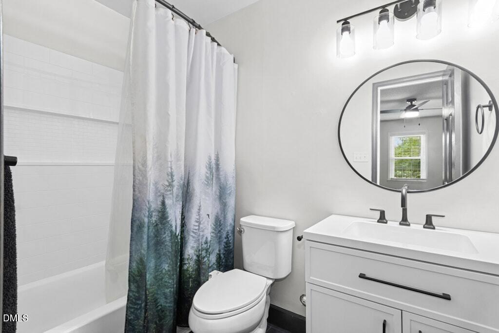 106 Village Court Garner, NC 27529 - Photo 19 of 38 a bathroom with a toilet a sink and a mirror