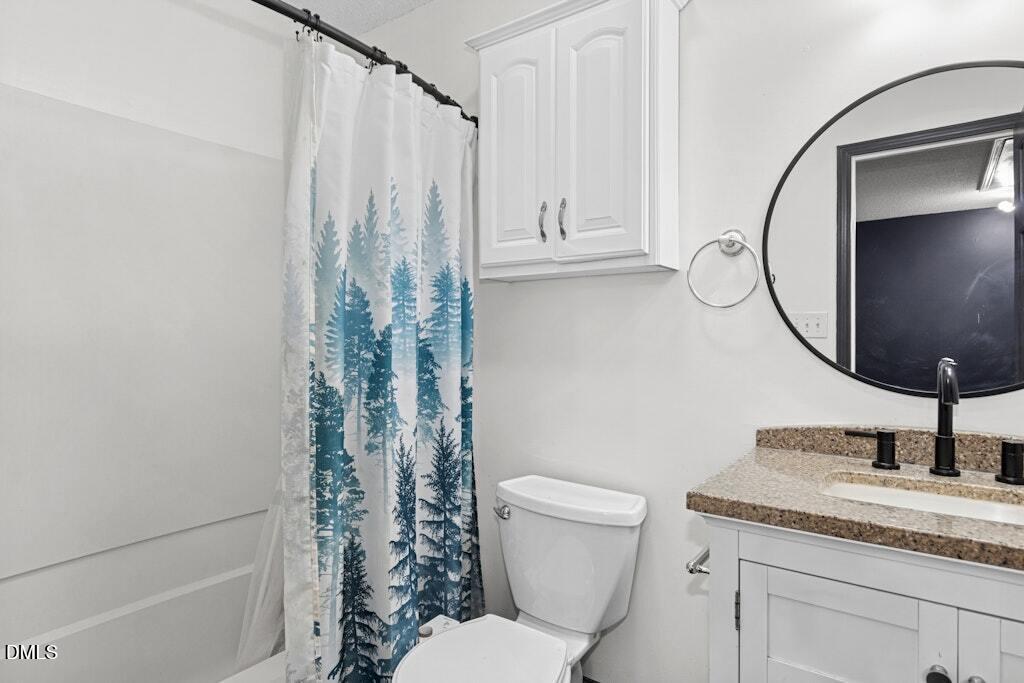 106 Village Court Garner, NC 27529 - Photo 22 of 38 a bathroom with a granite countertop toilet sink and mirror