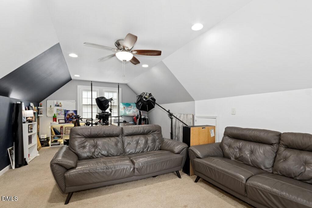 106 Village Court Garner, NC 27529 - Photo 23 of 38 a living room with furniture ceiling fan and a rug