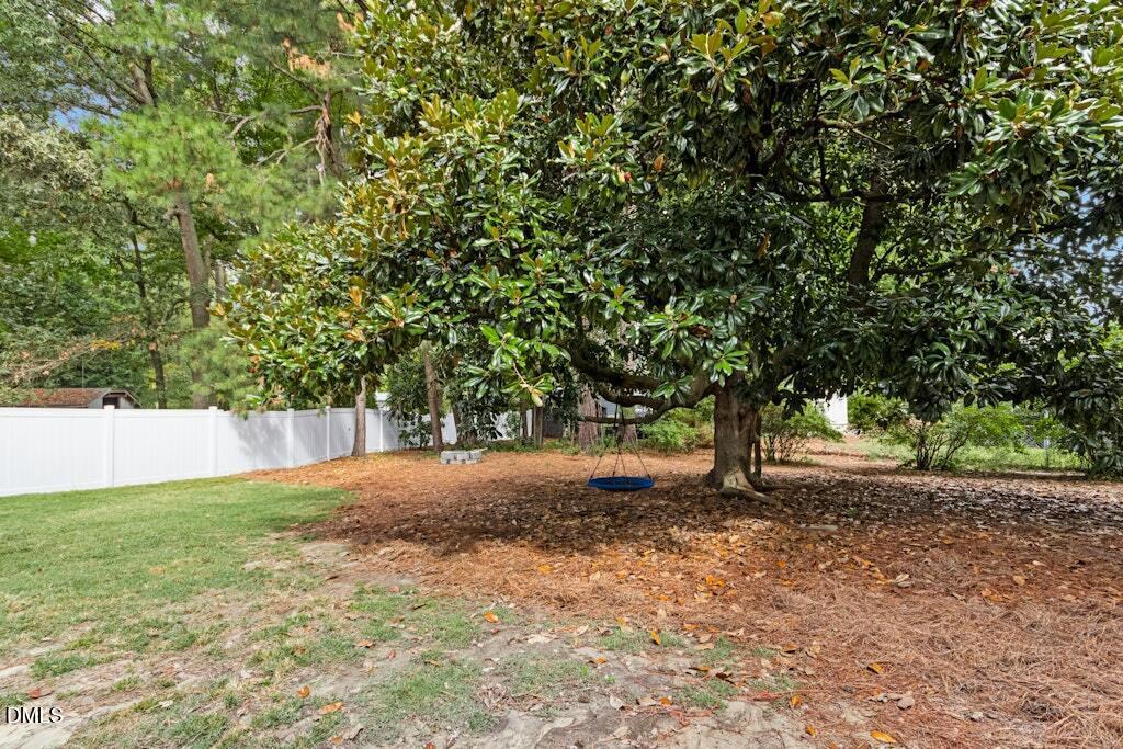 106 Village Court Garner, NC 27529 - Photo 24 of 38 a view of backyard with large trees
