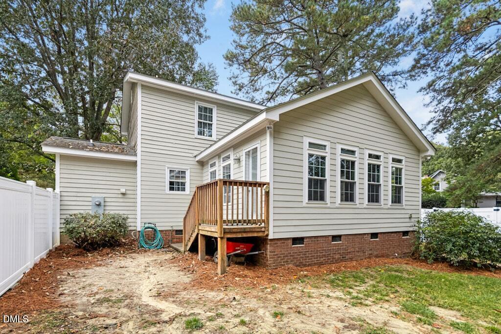 106 Village Court Garner, NC 27529 - Photo 25 of 38 a view of a house with a yard chairs and wooden fence