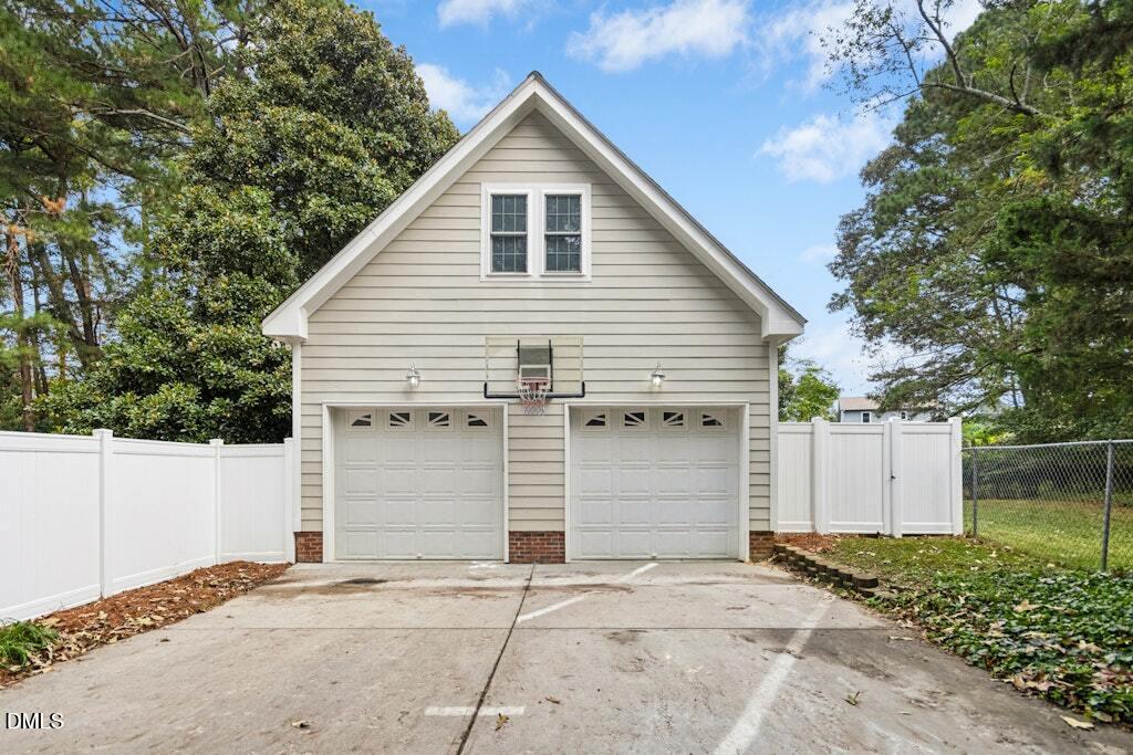 106 Village Court Garner, NC 27529 - Photo 26 of 38 a view of garage yard and tree