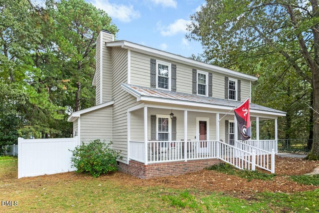 106 Village Court Garner, NC 27529 - Photo 2 of 38 a front view of a house with a porch