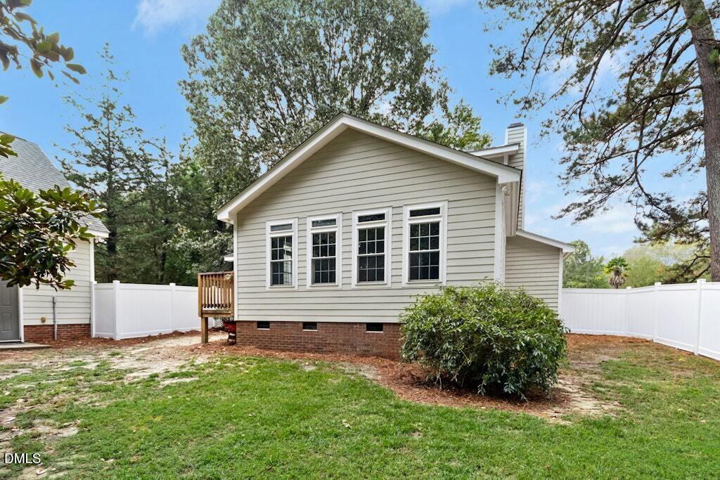 106 Village Court Garner, NC 27529 - Photo 27 of 38 a house with a white roof and wooden fence