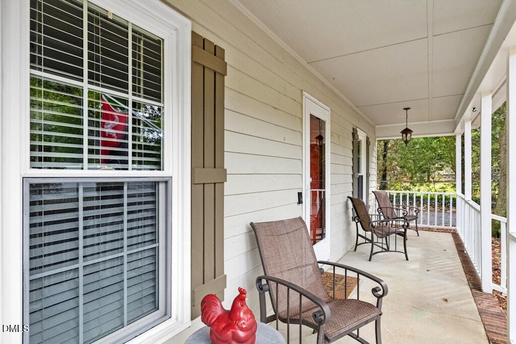 106 Village Court Garner, NC 27529 - Photo 4 of 38 a view of a chair and table in the balcony