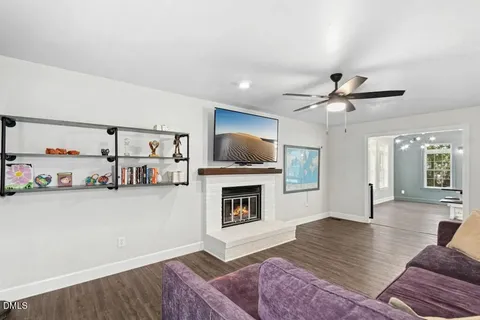 a front view of a house with a garden and trees