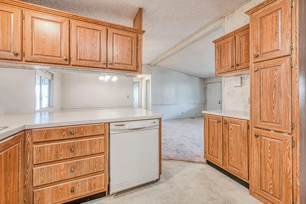 a kitchen with granite countertop cabinets stainless steel appliances and counter space