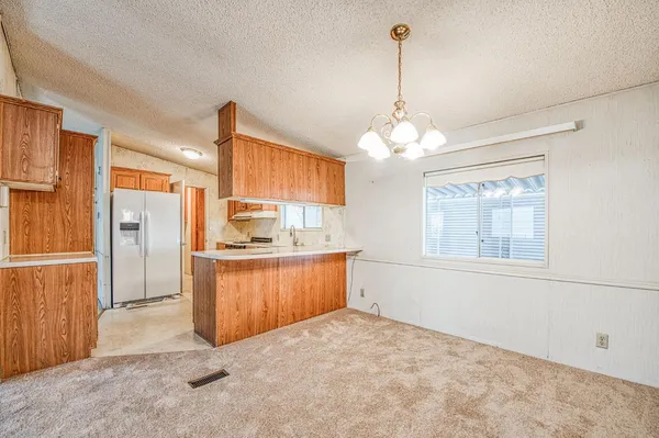 a open kitchen with window cabinets and stainless steel appliances