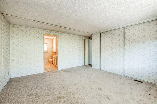a view of an empty room and a window