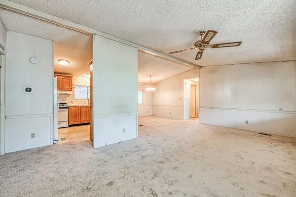 a view of a patio with table and chairs potted plants and large tree