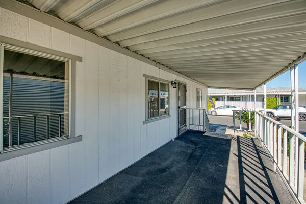a view of a porch with wooden floor