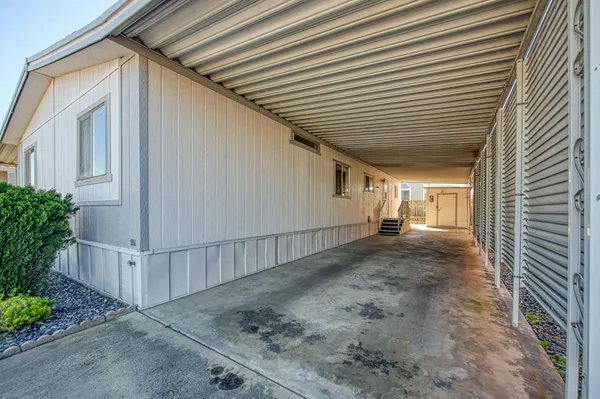 a view of a patio with couches table and chairs and potted plants