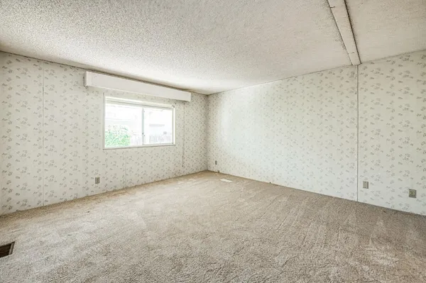 a view of an empty room and a window