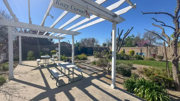 a view of a patio with couches table and chairs and potted plants