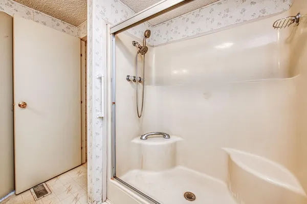 a kitchen with granite countertop white cabinets and white appliances