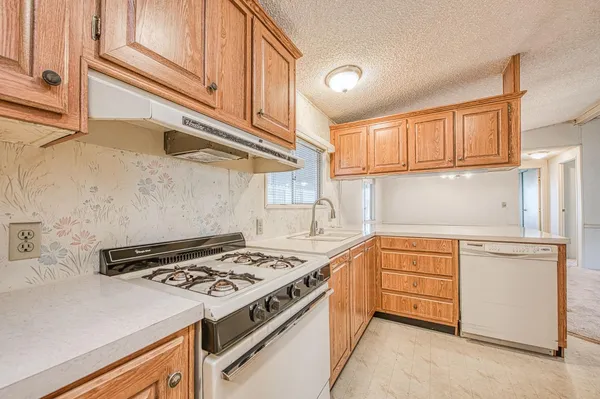 a kitchen with stainless steel appliances granite countertop a stove and a refrigerator