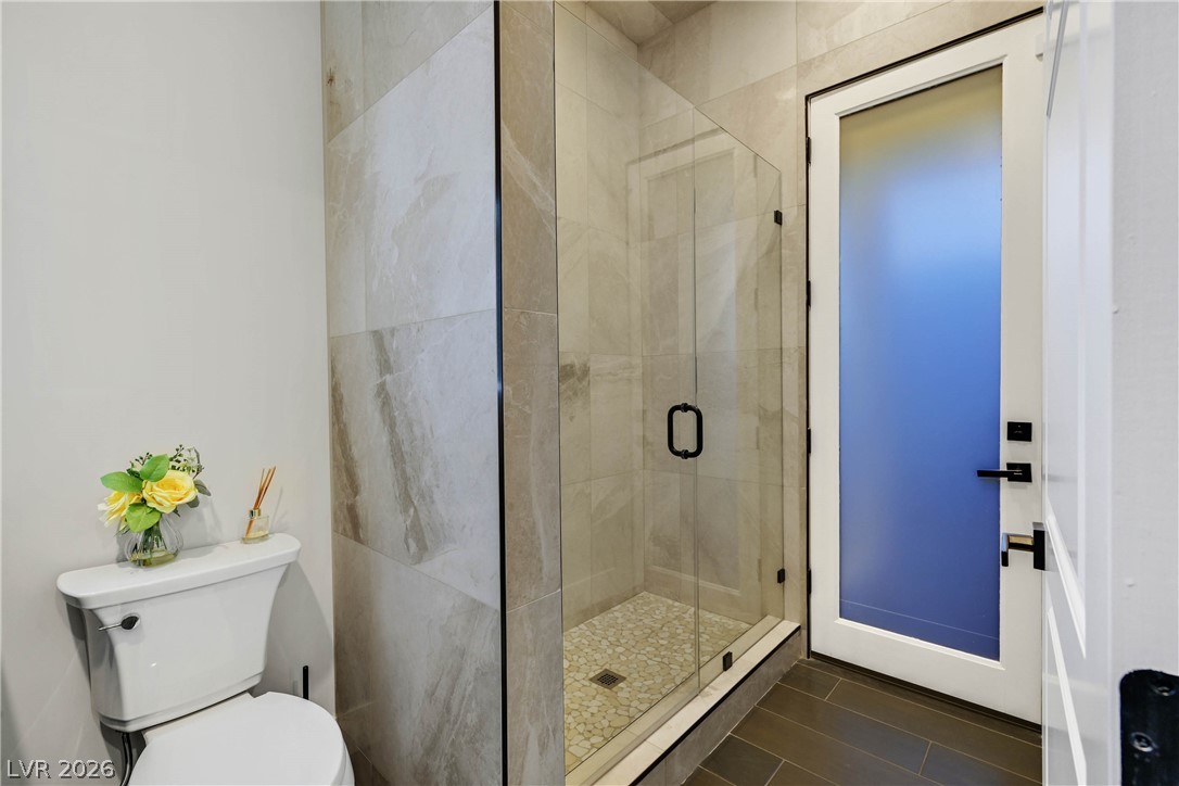 6 Rue Du Ville Henderson, NV 89011 - Photo 53 of 99 This bathroom features a contemporary shower with tile flooring and a sleek design.
