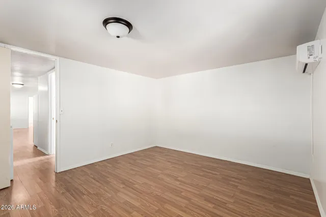 a view of a room with wooden floor