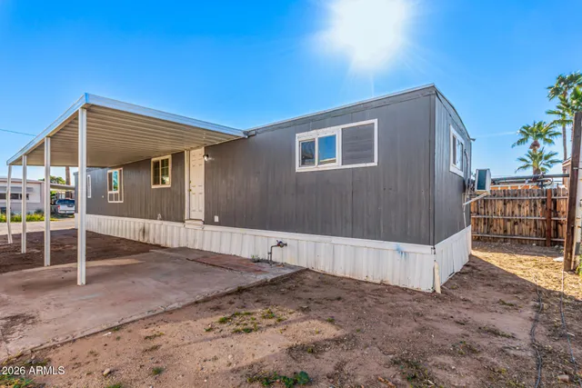 a view of a house with wooden fence