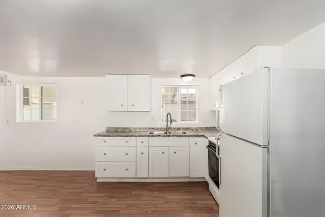 a kitchen with stainless steel appliances granite countertop a refrigerator and a stove top oven