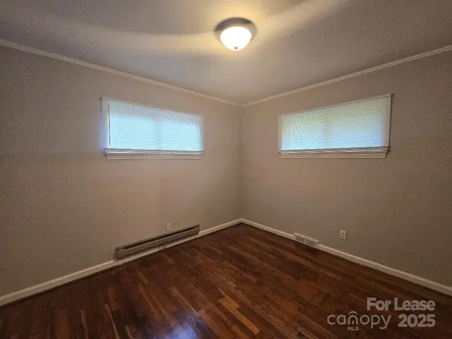 a room with a wooden floor and a window
