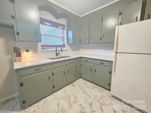 a kitchen with a sink and a refrigerator