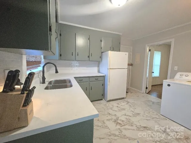 a kitchen with a refrigerator sink and stove
