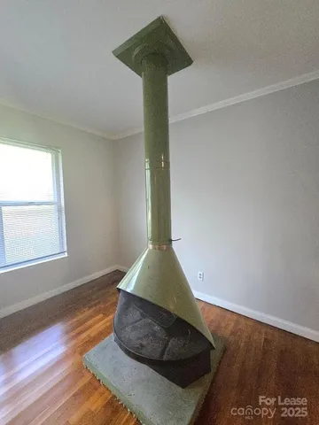 a room with wooden floor and a rug