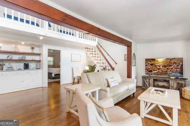 a living room with furniture and a flat screen tv