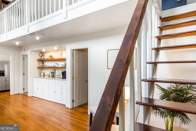 a view of staircase with white walls and a window