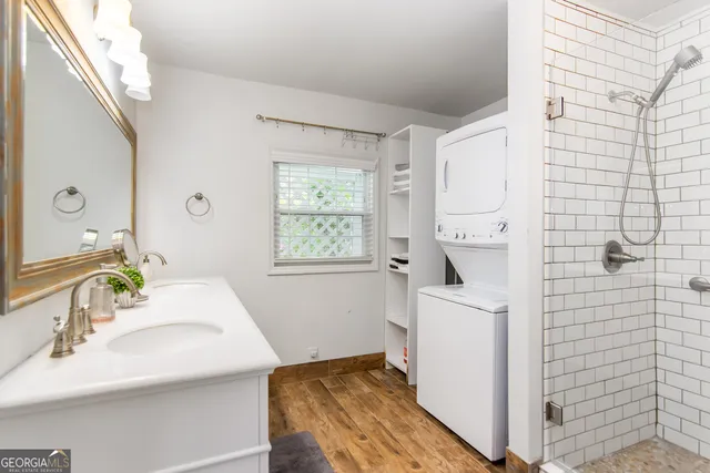 a bathroom with a sink a mirror and a shower