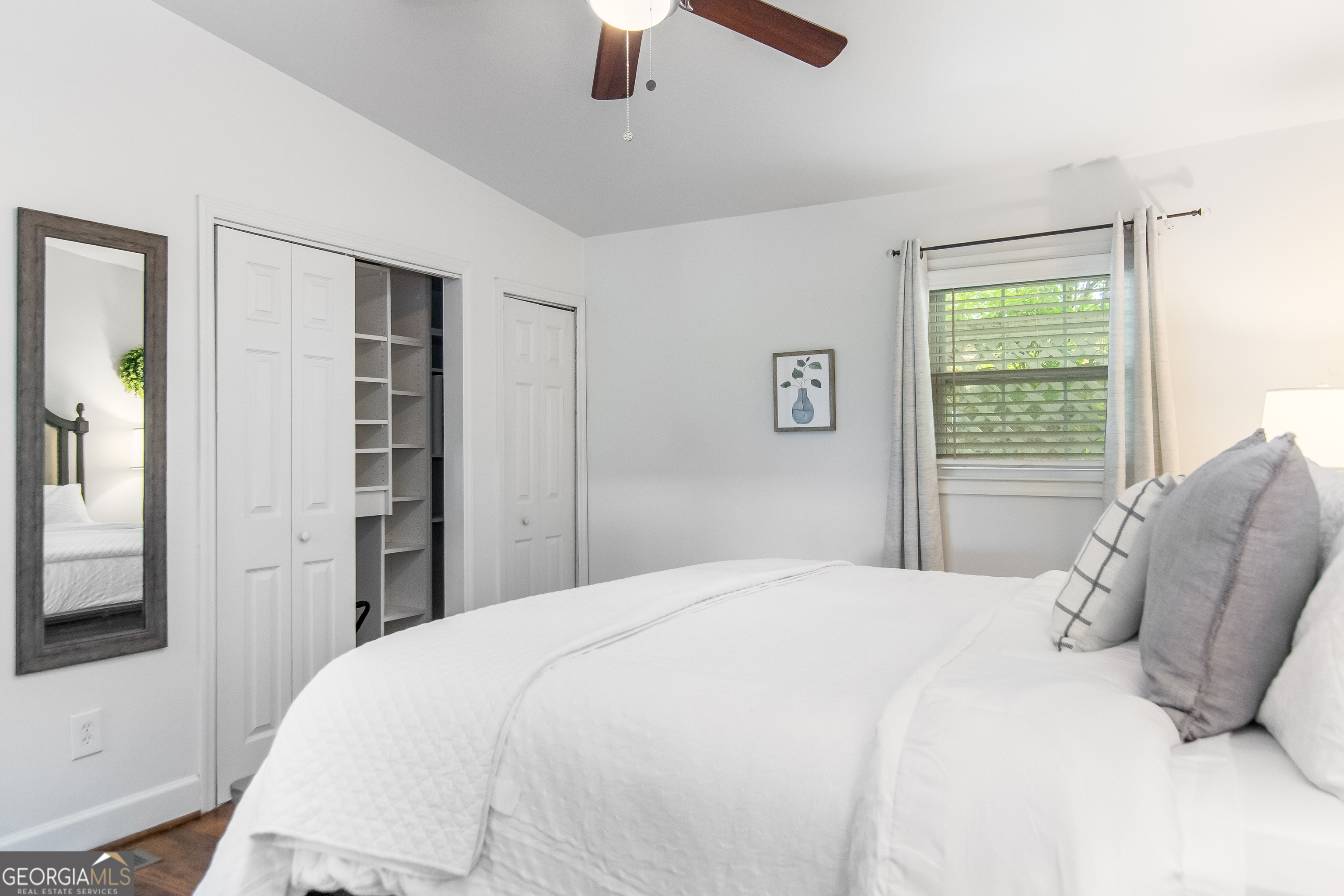 1056 Sky Hawk Mountain Road Hiawassee, GA 30546 - Photo 24 of 50 a bedroom with a large bed and a chandelier