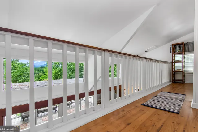 a view of wooden floor and windows