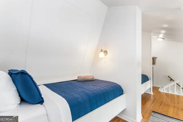 a bedroom with a bed and a chair