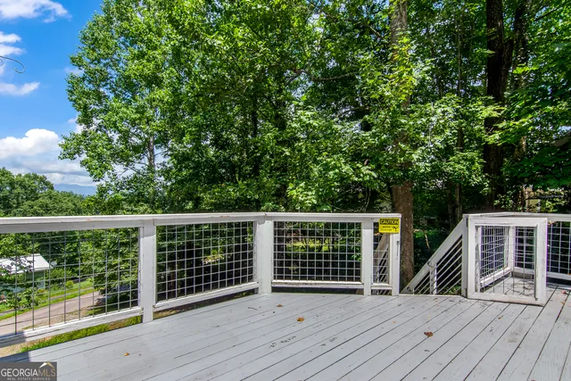 a balcony with wooden floor and fence