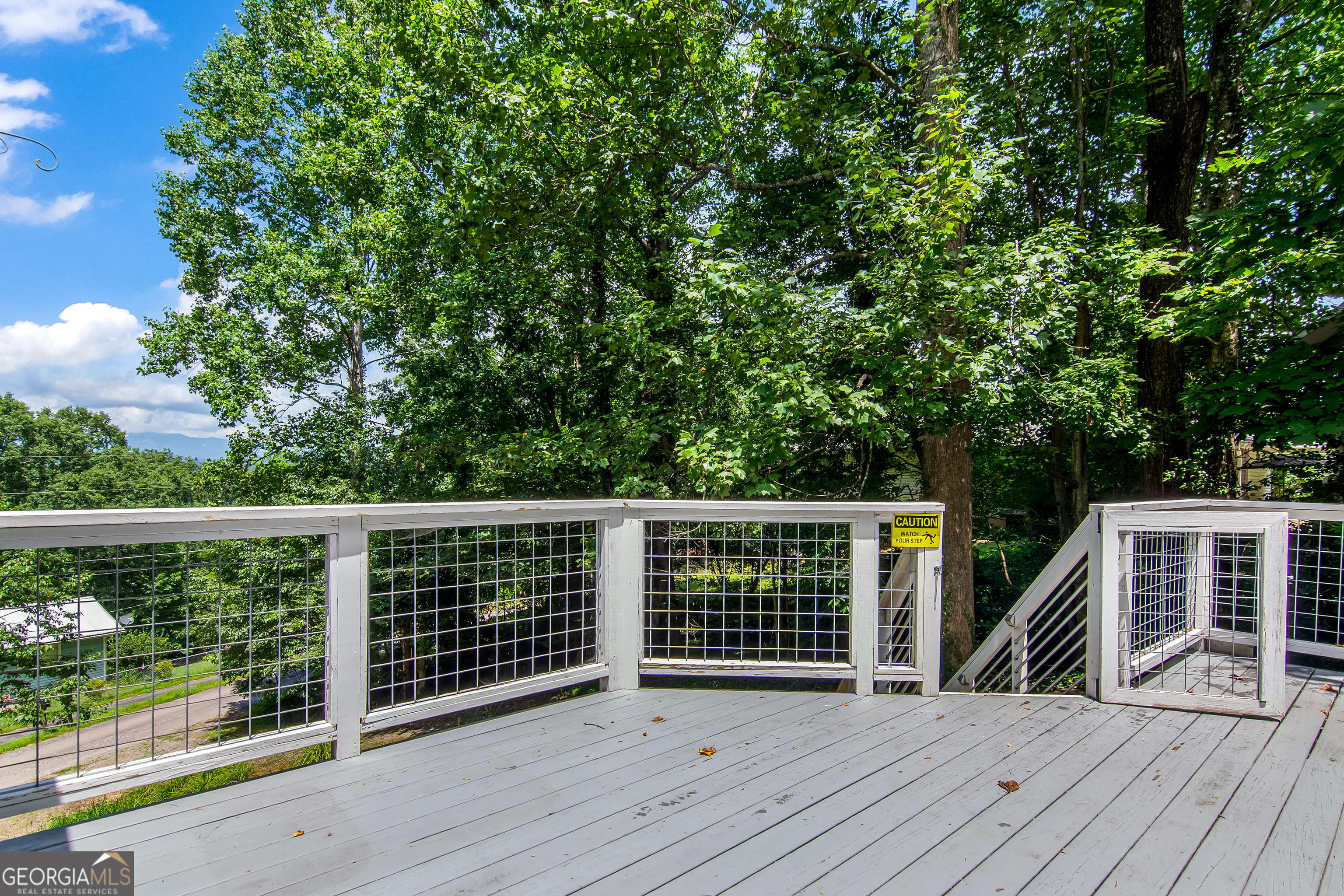 1056 Sky Hawk Mountain Road Hiawassee, GA 30546 - Photo 32 of 50 a balcony with wooden floor and fence