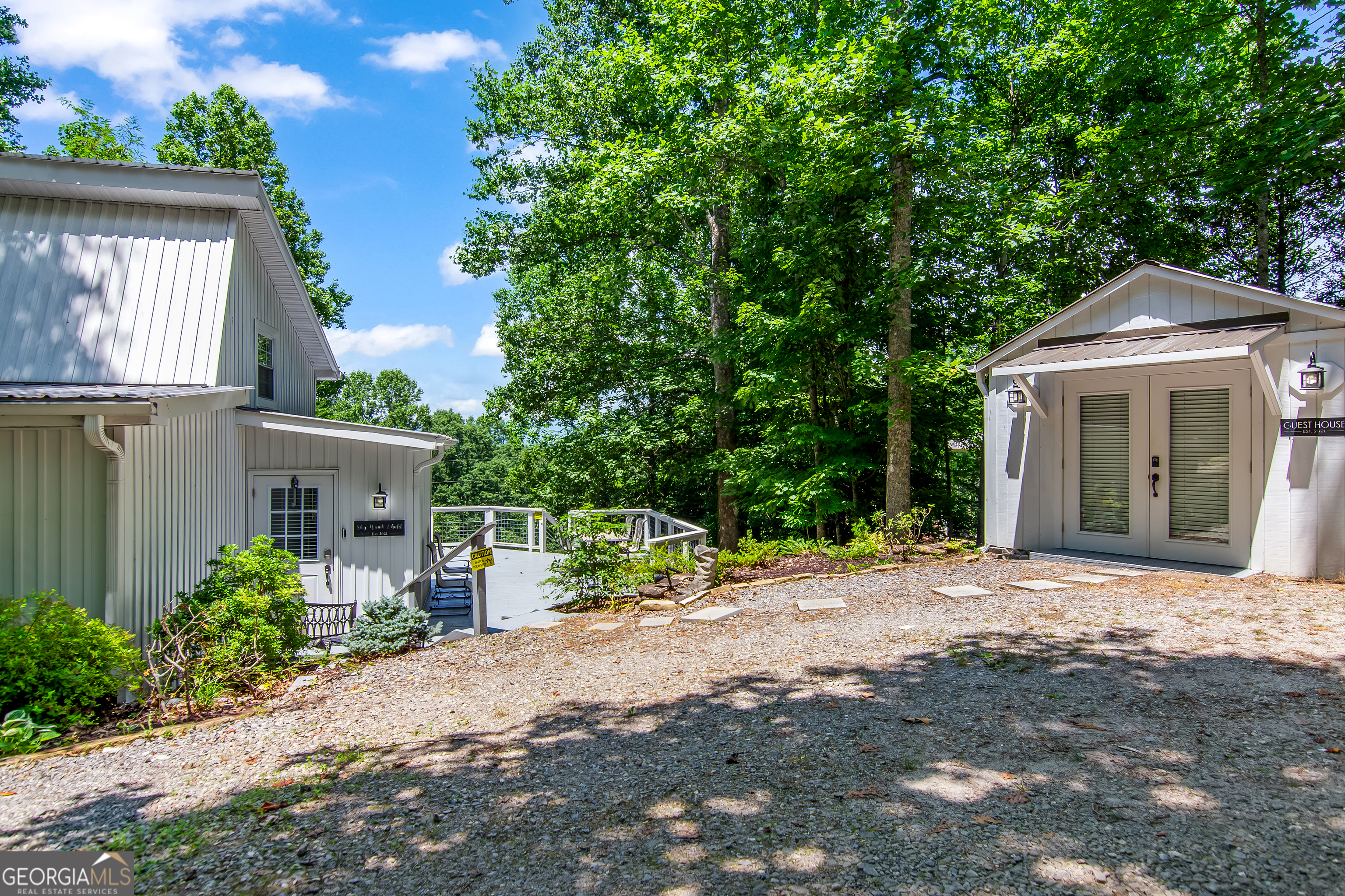 1056 Sky Hawk Mountain Road Hiawassee, GA 30546 - Photo 37 of 50 a front view of a house with a yard and potted plants