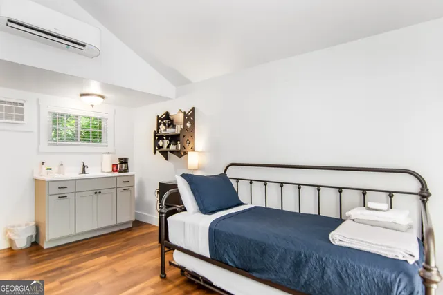 a bedroom with a bed window and a table in it